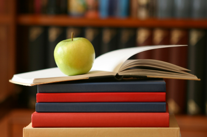 apple balanced on stack of books